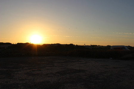 dramatic sunset at the beach with cloudy skyの写真素材