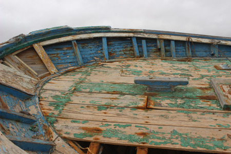 old abandoned fisherboat shipwreck at the coastの写真素材
