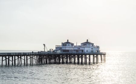 pier in Malibu, California with early morning fog and sunlight glistening on the Pacific oceanのeditorial素材