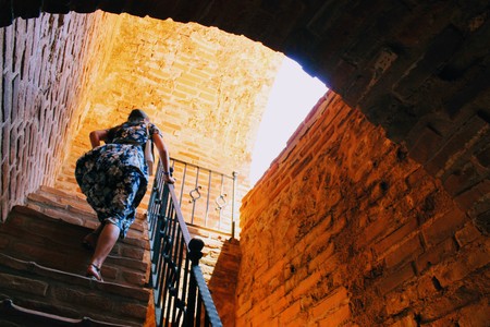 The woman climbs the steep stairs inside the Red Tower - the main fortification of the city (Alanya, Turkey).のeditorial素材