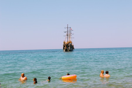 July, 2017 - Vacationers with inflatable mattresses swim in the sea at Cleopatra Beach (Alanya, Turkey).のeditorial素材