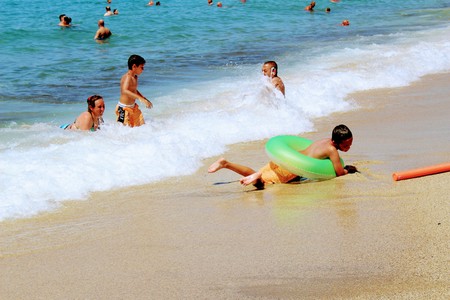 July, 2017 - Children and adults bathing in surf waves on Cleopatra Beach (Alanya, Turkey).のeditorial素材