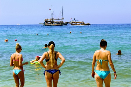 July, 2017 - Girls in a bikini stand in the surf band on Cleopatra Beach (Alanya, Turkey).のeditorial素材