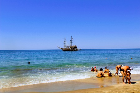 July, 2017 - Vacationers bathe in the sea and sunbathe in the sun on Cleopatra Beach (Alanya, Turkey).のeditorial素材