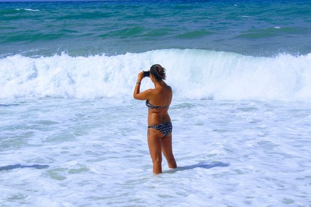 July, 2017 - A young girl makes a photo standing on the Cleopatra Beach (Alanya, Turkey).のeditorial素材