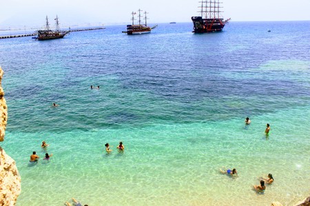 Vacationers bathe in crystal clear water (Alanya, Turkey).の写真素材