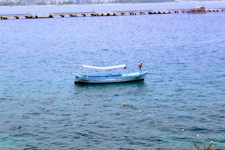 Blue fishing boat in the city harbor (Antalya, Turkey).のeditorial素材