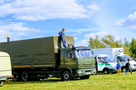 September, 16 2017, Tula, Russia - The International Military and Historical Festival "Kulikovo Field": men watch the performance from the roof of the truck.のeditorial素材