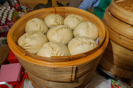Moscow, Russia - February 25, 2017: National Korean fast food - steamed pies pyan-se in a traditional wooden steamerのeditorial素材
