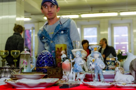 Moscow, Russia - March 19, 2017: Old antique porcelain and ceramic figures for sale on the flea market. Selective focusのeditorial素材