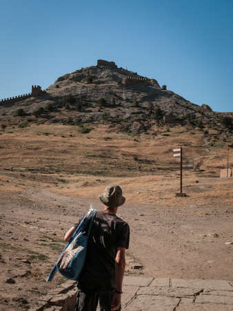 Crimea, Sudak - June 16, 2019: hiker at entrance to Soldaia Castle - medieval Genoese fortress, famous landmarkのeditorial素材