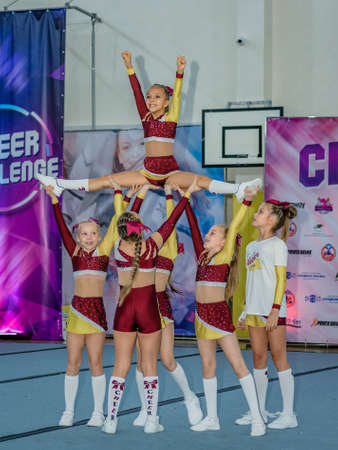 Moscow, Russia - December 22, 2019: Little european girls of school age perform at cheerleading competitions, show trickのeditorial素材