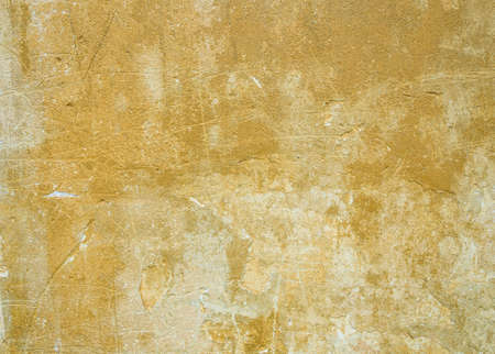 Old of dilapidated wall for texture or background, rough aged surface, remnants of peeling plaster, grunge-style plasterの写真素材