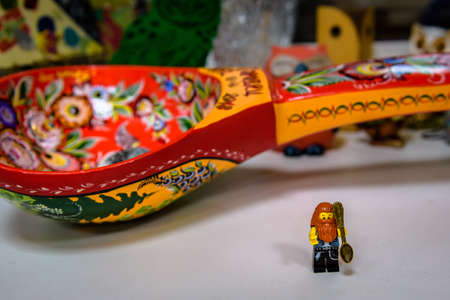 Vladimir, Russia - March 29, 2019: Funny bearded hipster lego-man minifigure with small souvenir spoon in Spoon Museumのeditorial素材