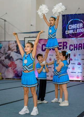 Moscow, Russia - December 22, 2019: Little european girls of school age perform at cheerleading...