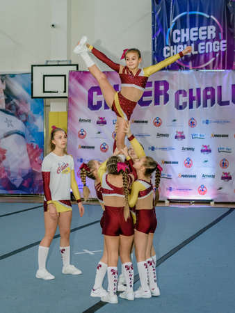 Moscow, Russia - December 22, 2019: Little european girls of school age perform at cheerleading competitions, show trickのeditorial素材