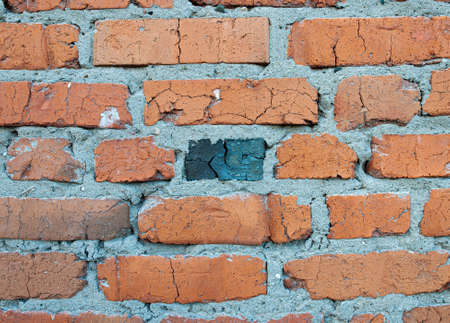 Old weathered red brick wall for texture or background, classic rough aged brickwork, vintage masonry with cement mortarの写真素材