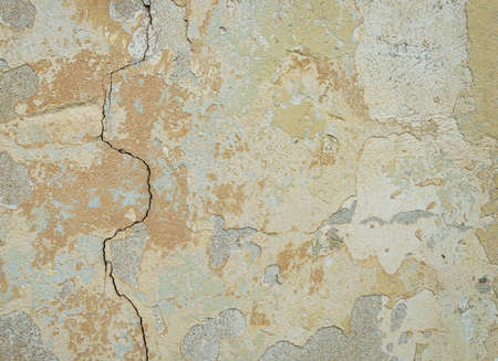 Old wall for texture or background, rough aged surface, remnants of peeling plaster, crack in the...