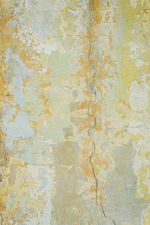 Old wall for texture or background, rough aged surface, remnants of peeling plaster, crack in the grunge-style wallの写真素材
