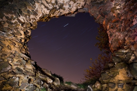 Big Hole in and castle brick wall with falling stars on the skyの写真素材