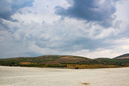 lifeless shore of small white pebbles and clay on lake Salda in Turkeyの写真素材
