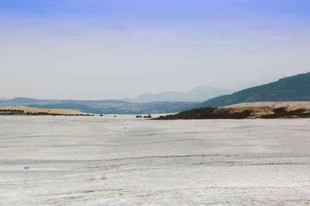 desolate and lifeless white shore of lake Salda against the background of mountainsの写真素材