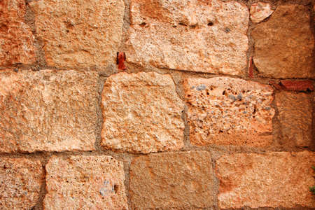 background of rows of blocks of the ancient wall at sunsetの写真素材