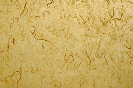 Natural paper background in yellow with fibersの写真素材