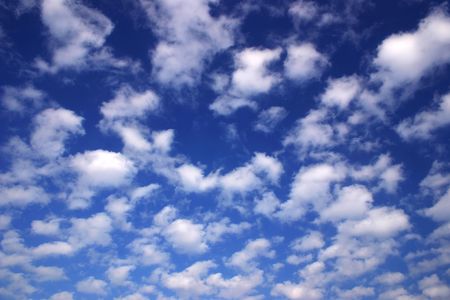 Deep blue sky with lots of fluffy white cloudsの写真素材