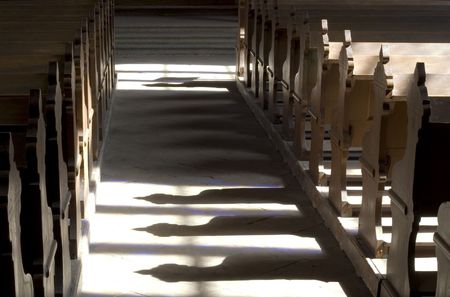 Church benches casting shaddows on the floorの写真素材
