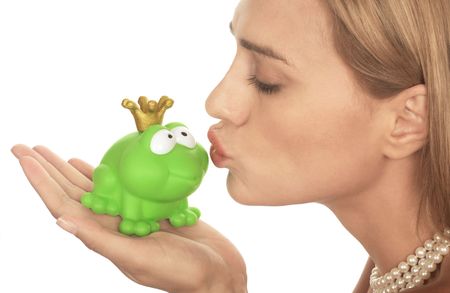 Frog price being kissed by a beautiful glamour model isolated on whiteの写真素材