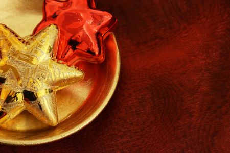 Golden and red stars on a golden plateの写真素材