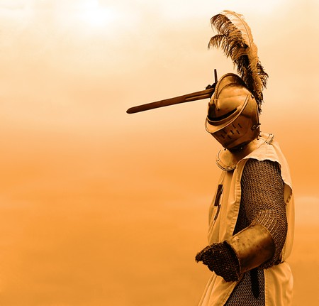 Knight with a sword in mail shirt, armament and helmet (copy space)