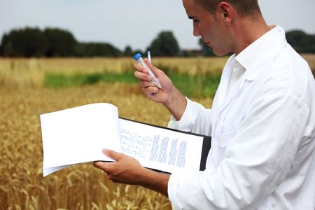 Scientist in the field collecting sample for analysisの写真素材