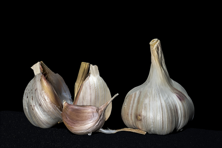 head and clove of garlic on black backgroundの写真素材