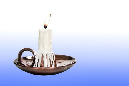 candle in candlestick brown on a gradient backgroundの写真素材