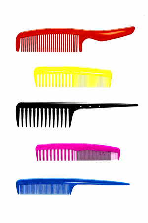 five plastic hair combs on a white backgroundの写真素材