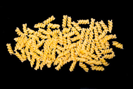 Italian raw pasta named Fusilli on black backgroundの写真素材
