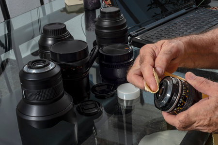 cleaning photographic lenses on the work tableの写真素材