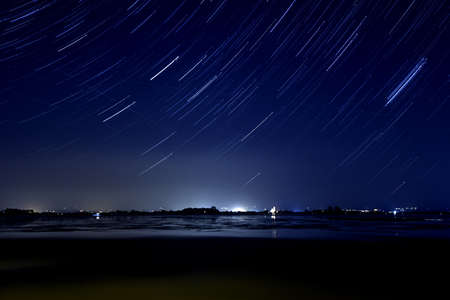 trail of bright stars at night and the Earth's rotation