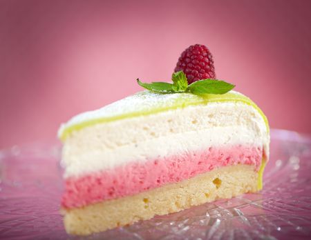Slice of cake against pink background