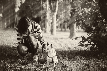 Pretty woman and little dog in the parkの写真素材