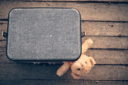 Teddy bear in old bagの写真素材