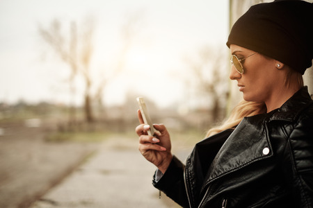 Young blonde girl with mobile phoneの写真素材
