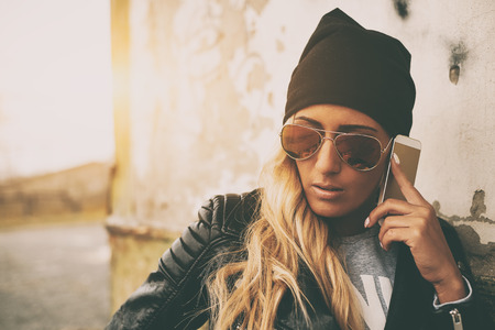 Young blonde girl with mobile phoneの写真素材