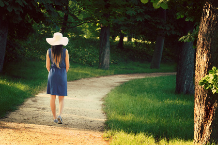 Attractive young adult woman in outdoor blue dressの写真素材
