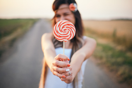 Young woman and lollipopの写真素材