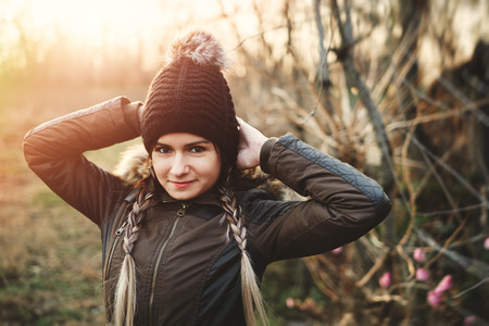 Winter portrait of young woman with raised hand braided hair