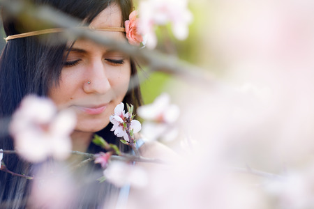 Young woman blossom tree portraitの写真素材