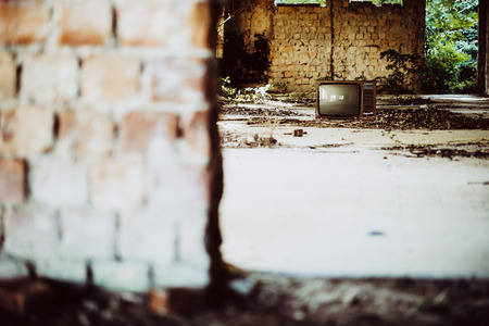 Old television in abandoned buildingの写真素材
